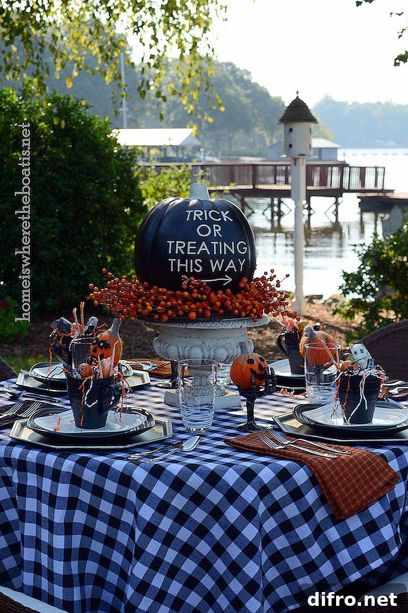 Outdoor Halloween table with black pumpkins and orange accents