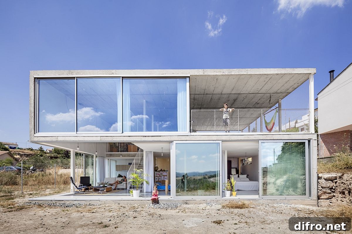Garage and studio sit on the upper level of the house while the living areas occupy the lower floor