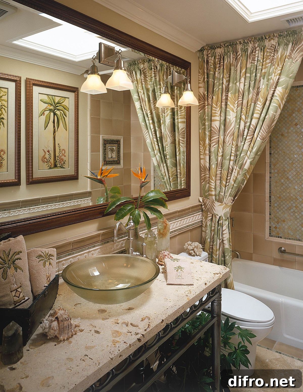 Pattern-filled tropical style bathroom in green with sconce lights