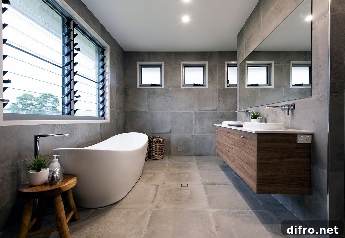 Contemporary bathroom in gray with a white freestanding bathtub