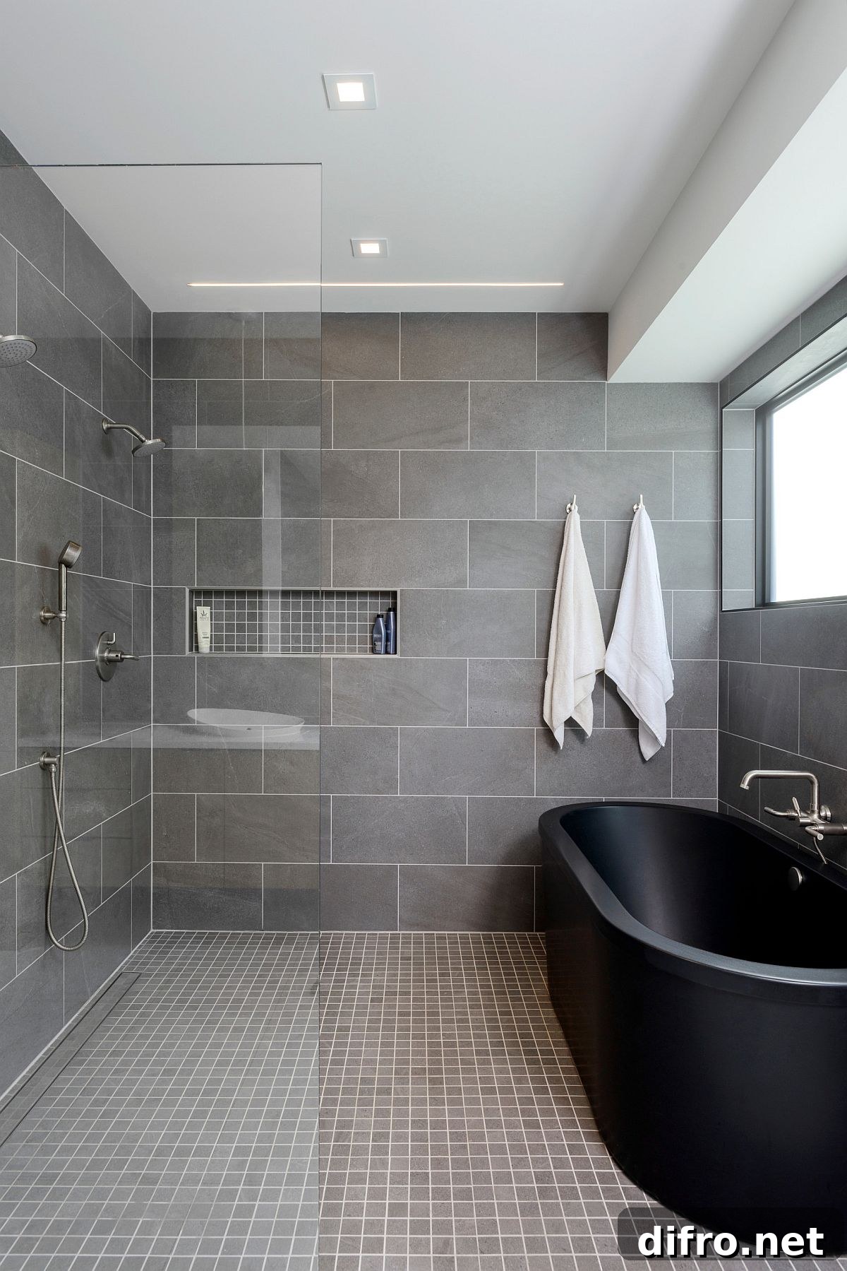 Black freestanding bathtub in a dramatic bathroom