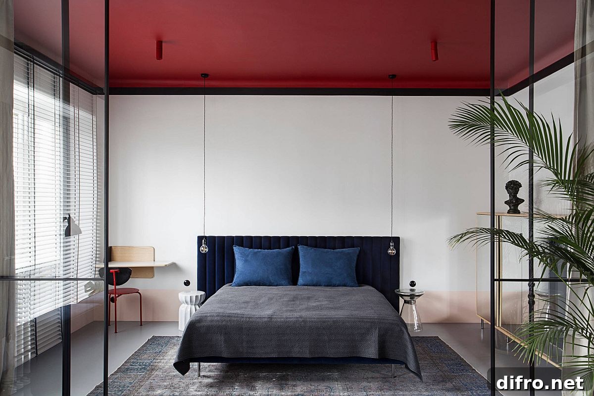 Red ceiling stealing the spotlight in a small white bedroom