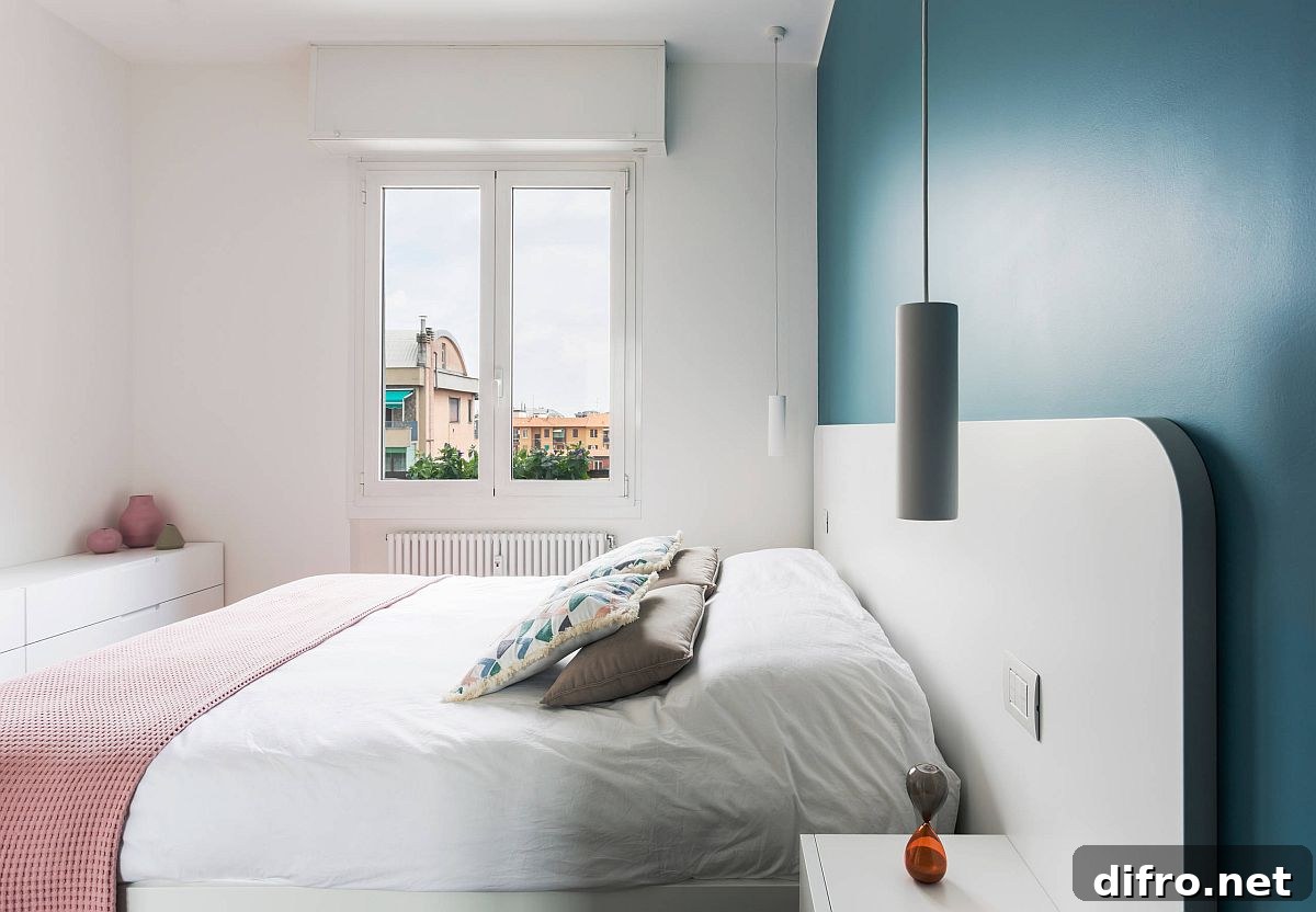 Gorgeous blue accent wall in a small white bedroom