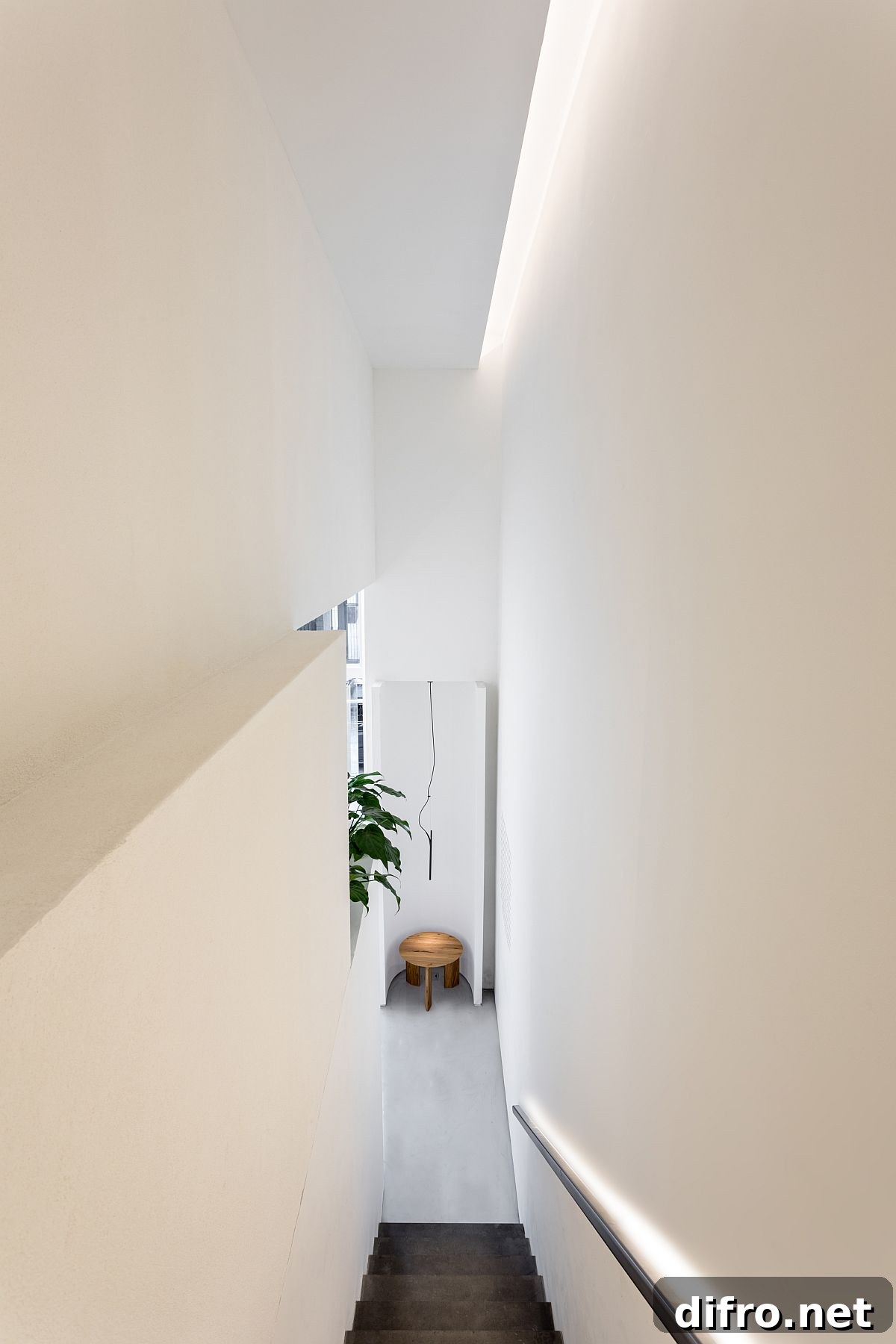 Staircase in white leading to the upper level of the store with smart lighting