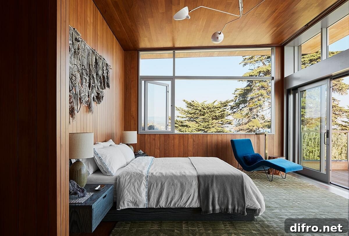 Gorgeous and cozy bedroom in wood with custom lighting is connected with the outdoors