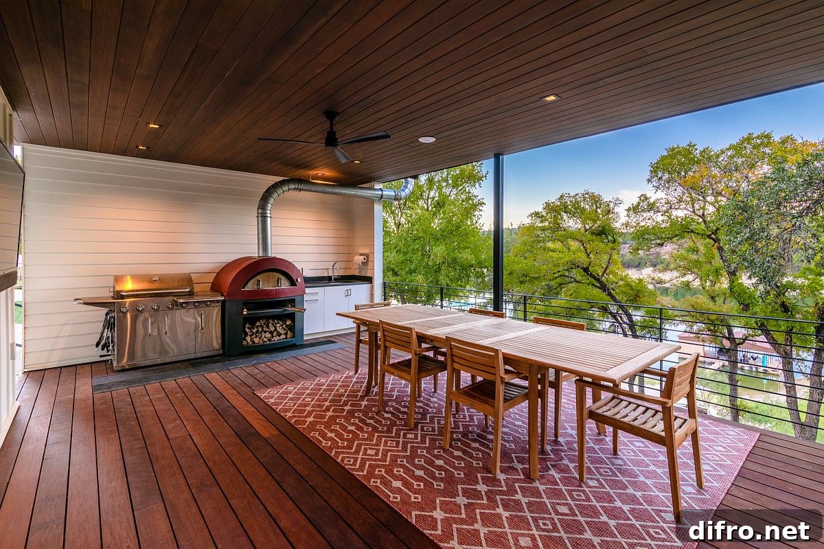 Modern farmhouse deck with dining space and barbecue