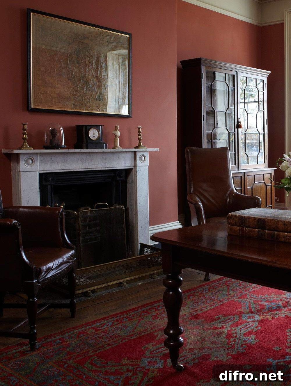 study with brown furniture, red wall and red carpet accent