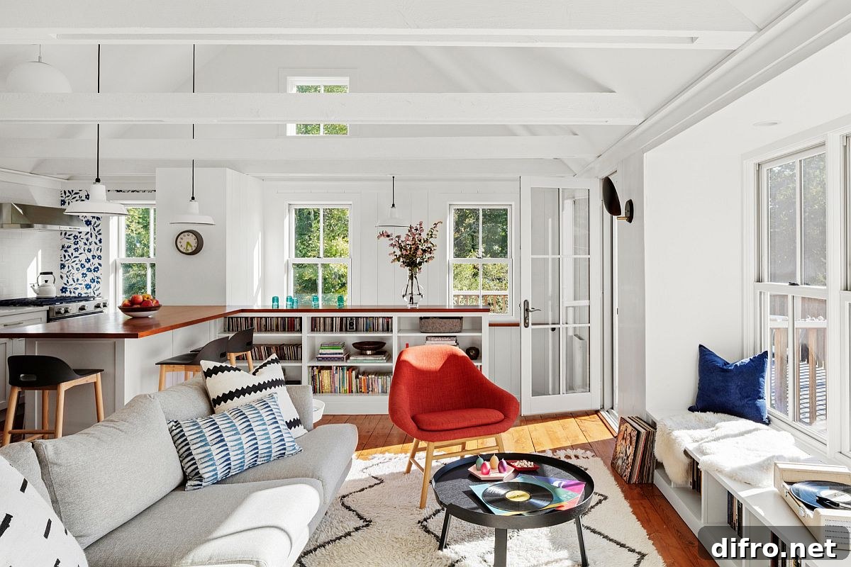 White living room with bookshelves and colorful decor