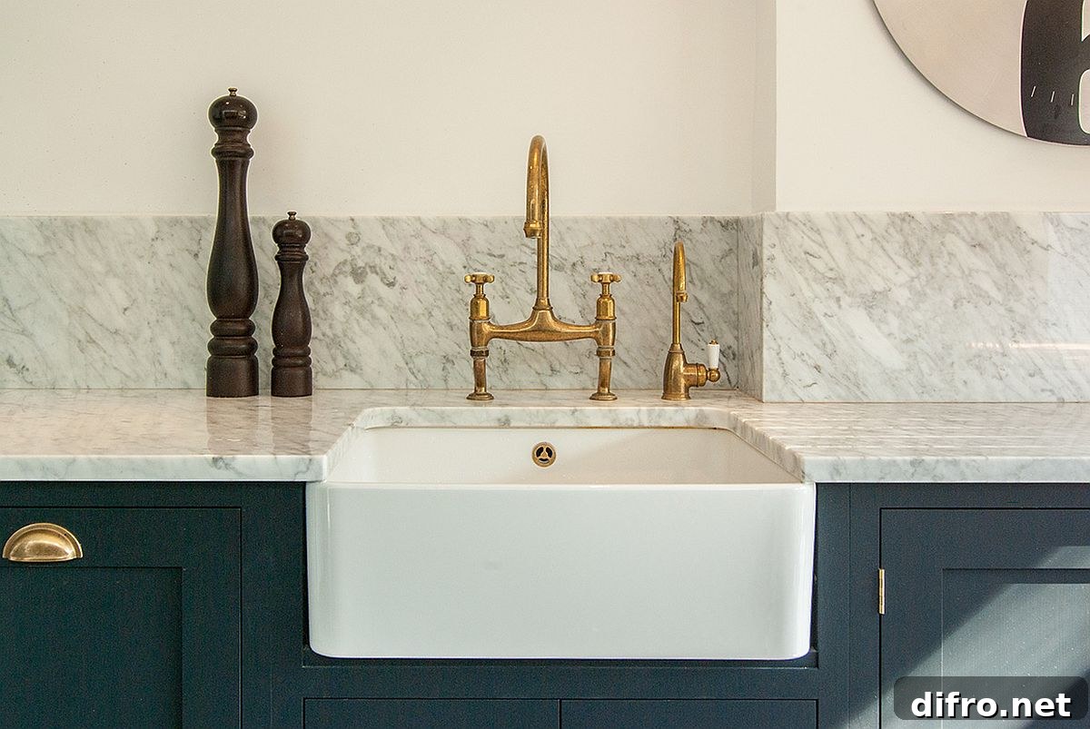 Kitchen of the home with marble countertops and classic blue cabinets