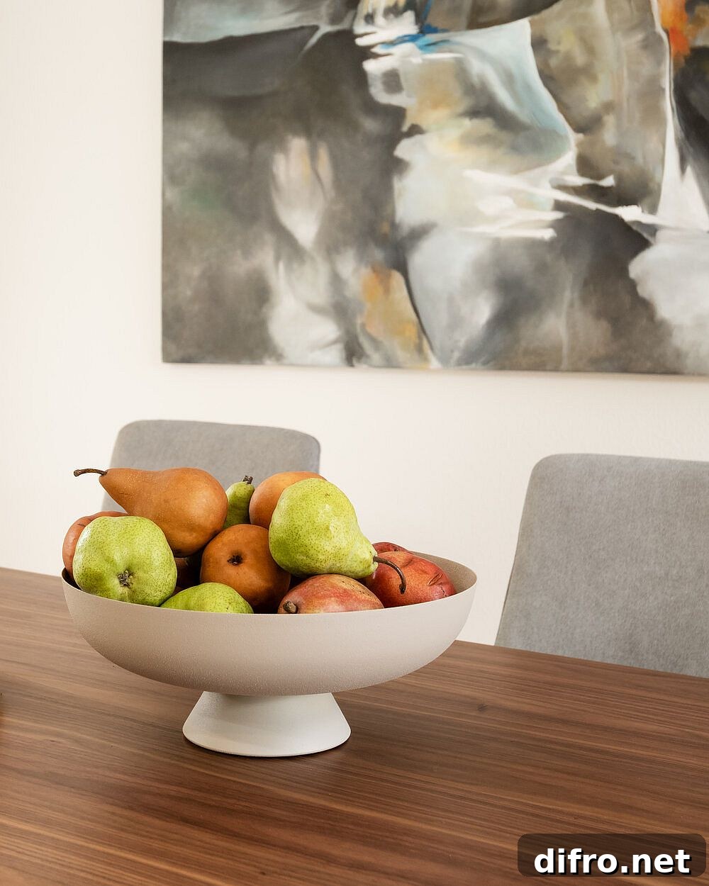 Modern dining area with large wooden table and neutral backdrop