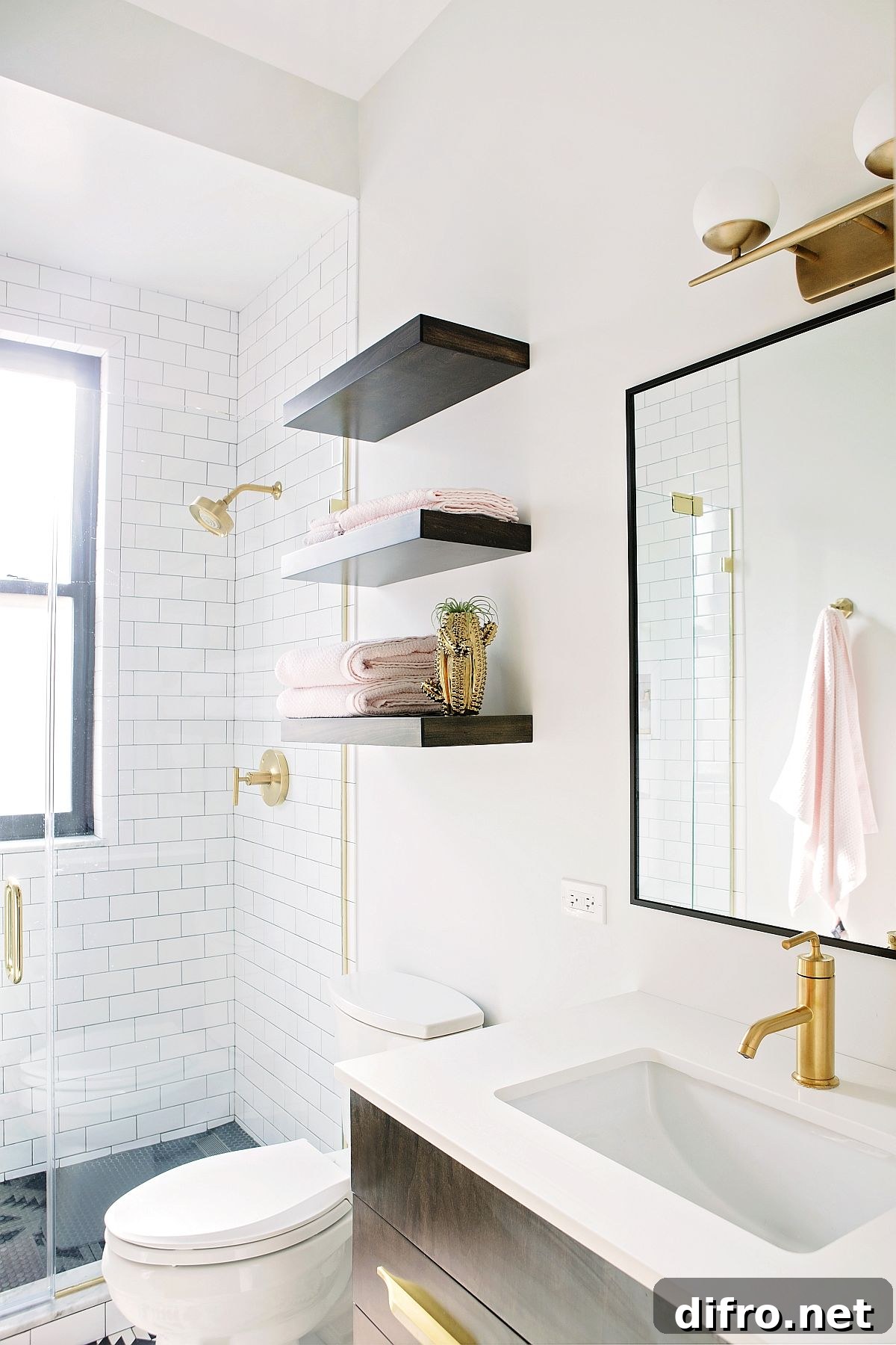 Guest bathroom in white with pops of black and gold that bring contrast
