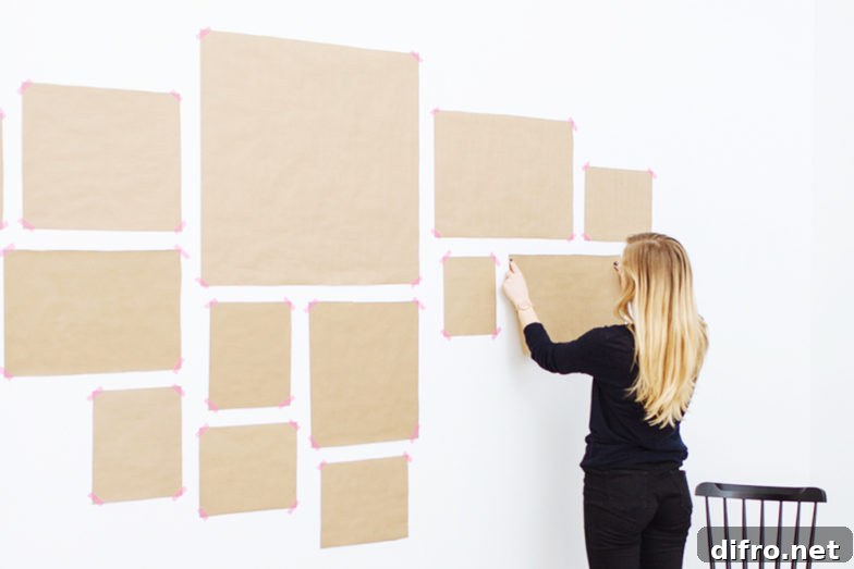 woman putting up templates for gallery wall