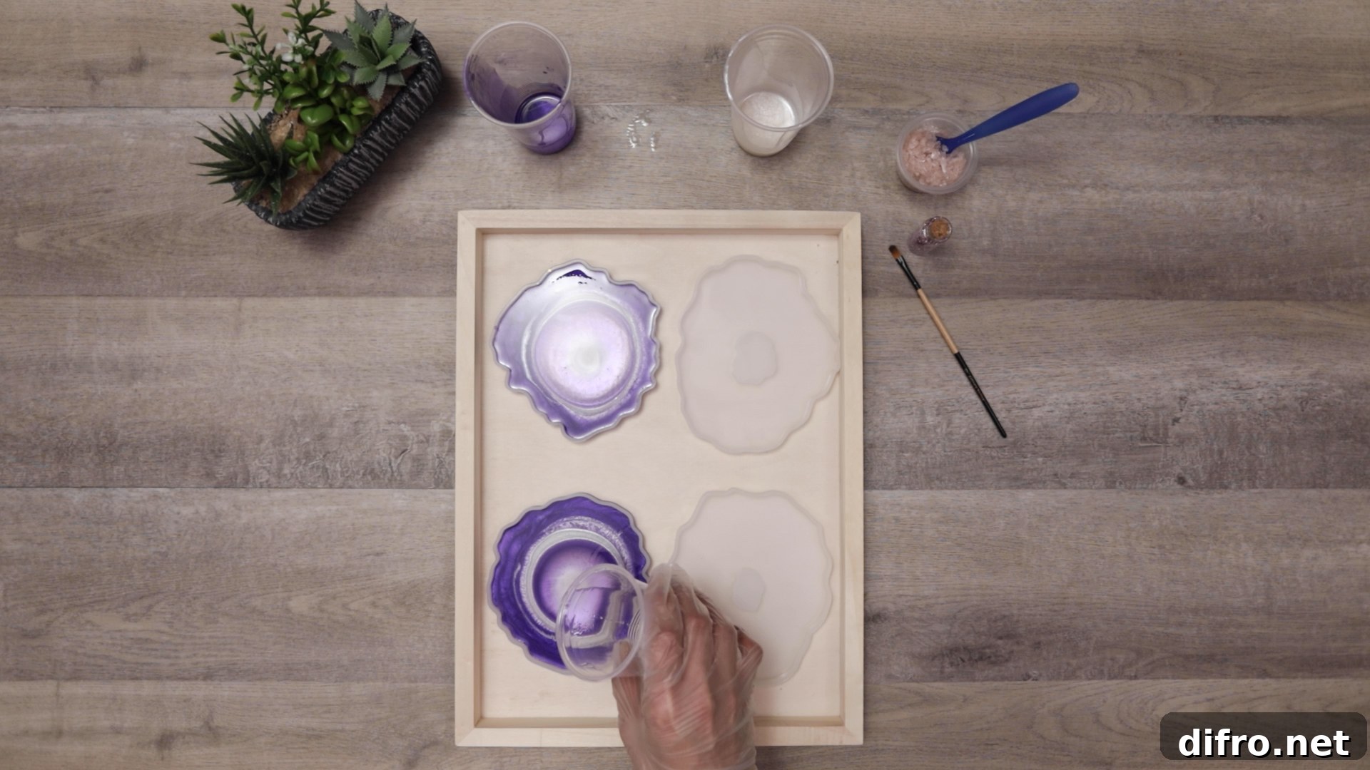 pouring clear resin into center of coasters to push color out