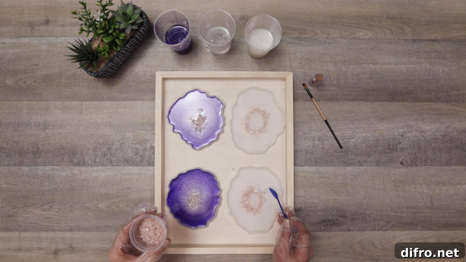 placing crushed glass into center of coaster molds