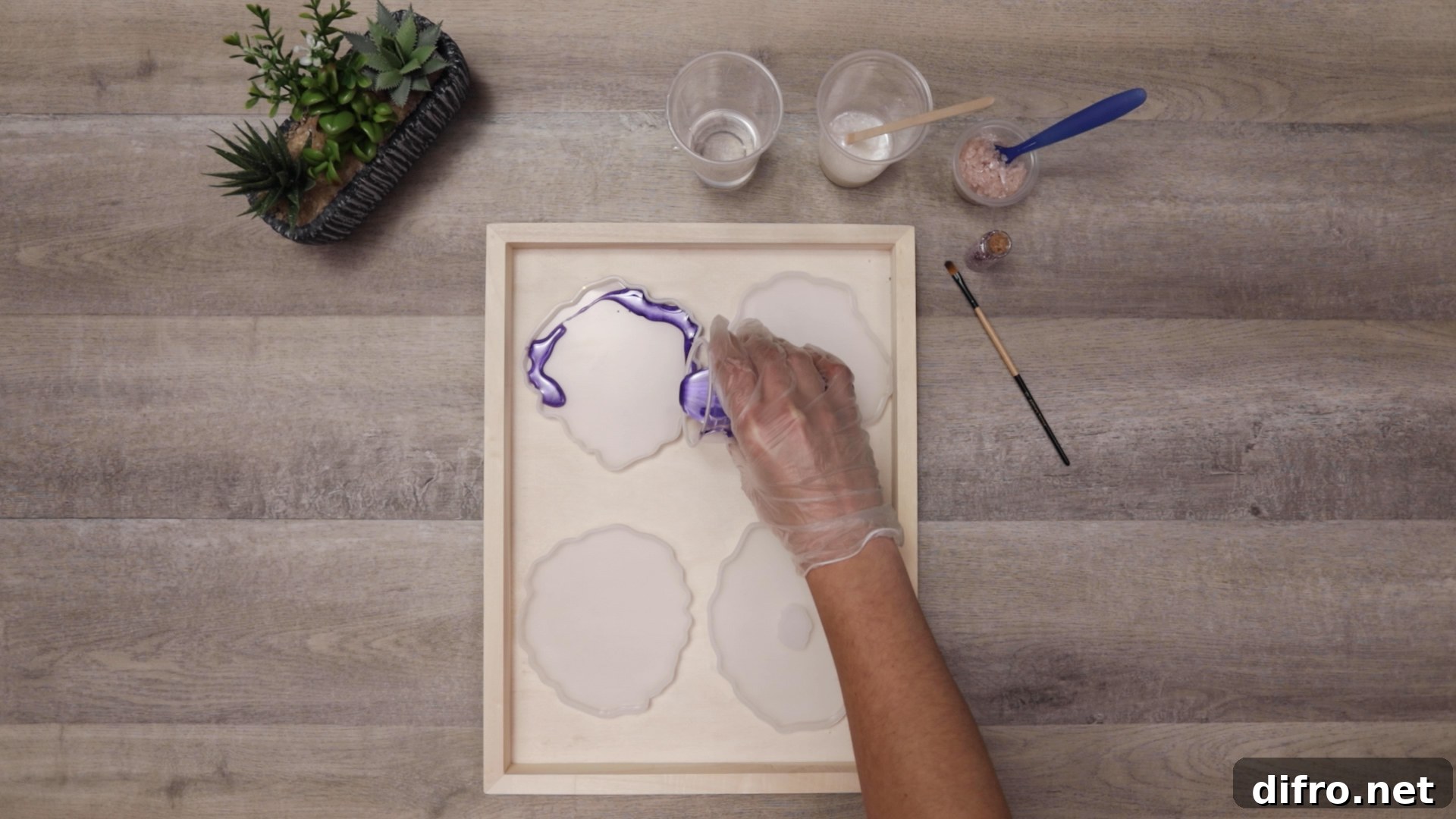 pouring purple resin into first coaster mold