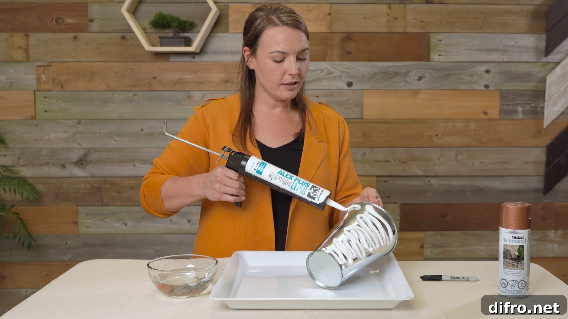 distributing DAP silicone caulking onto bucket