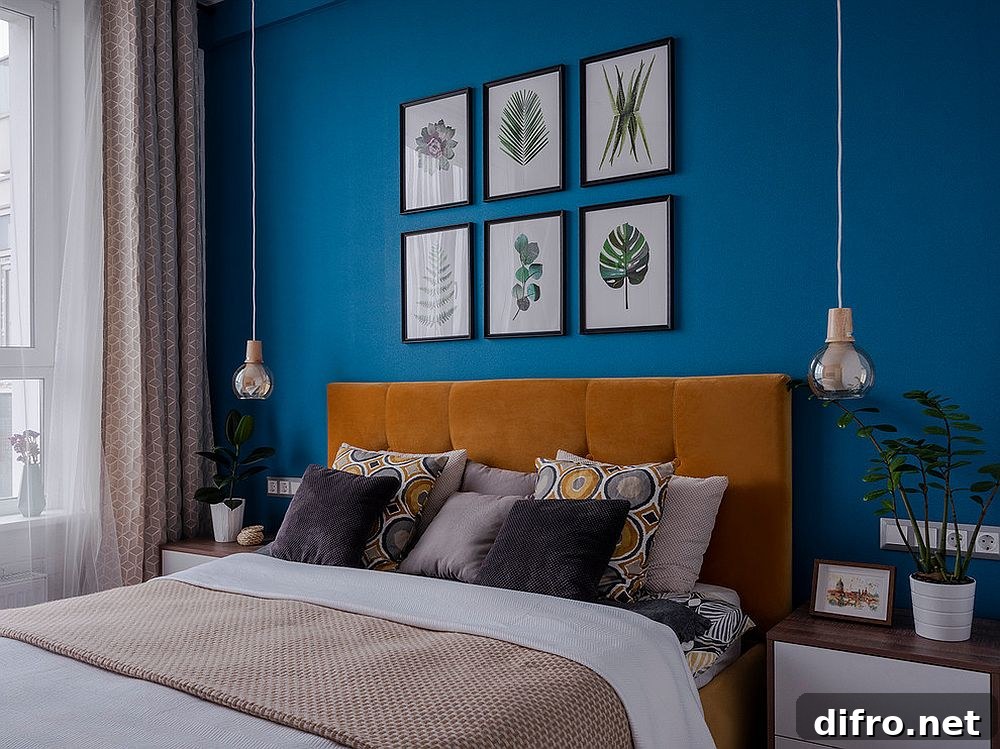 Blue accent wall with framed botanical artwork in a modern bedroom