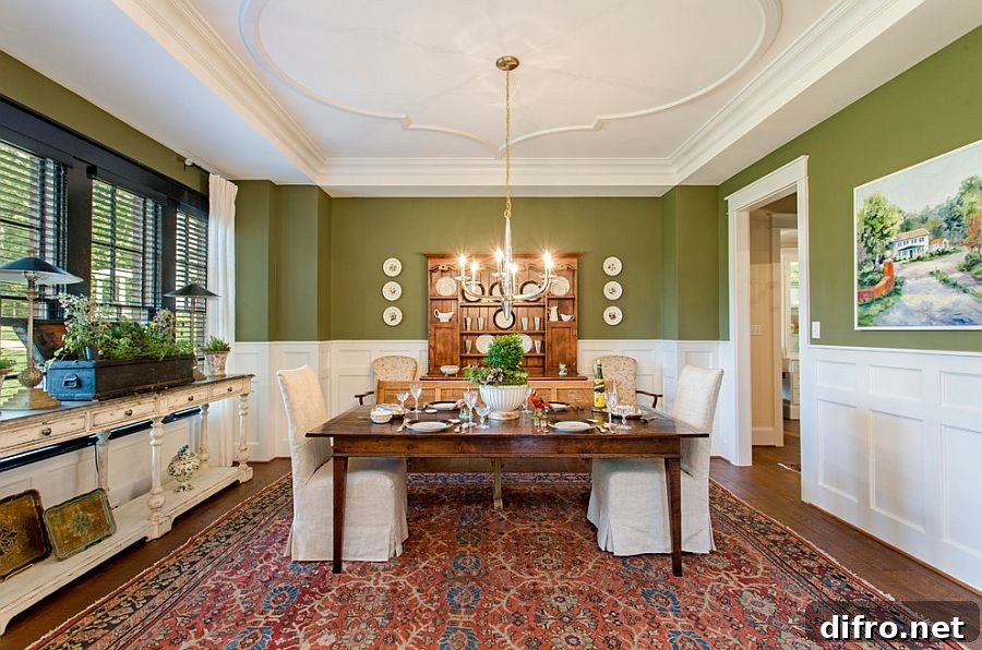 Transitional white and green dining room with wooden table