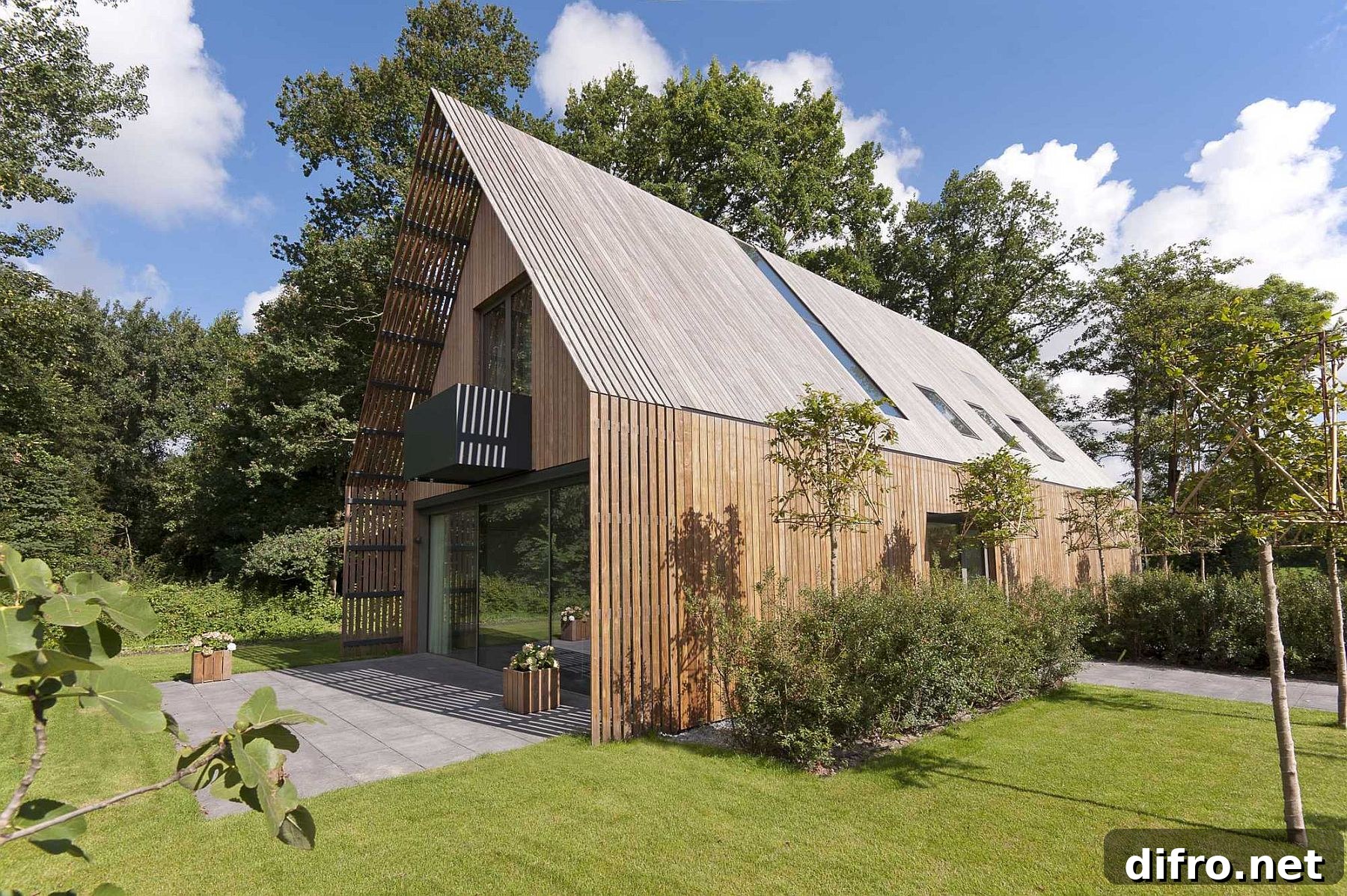 Exterior of the Forest Villa clad in modified wood, nestled against a lush forest