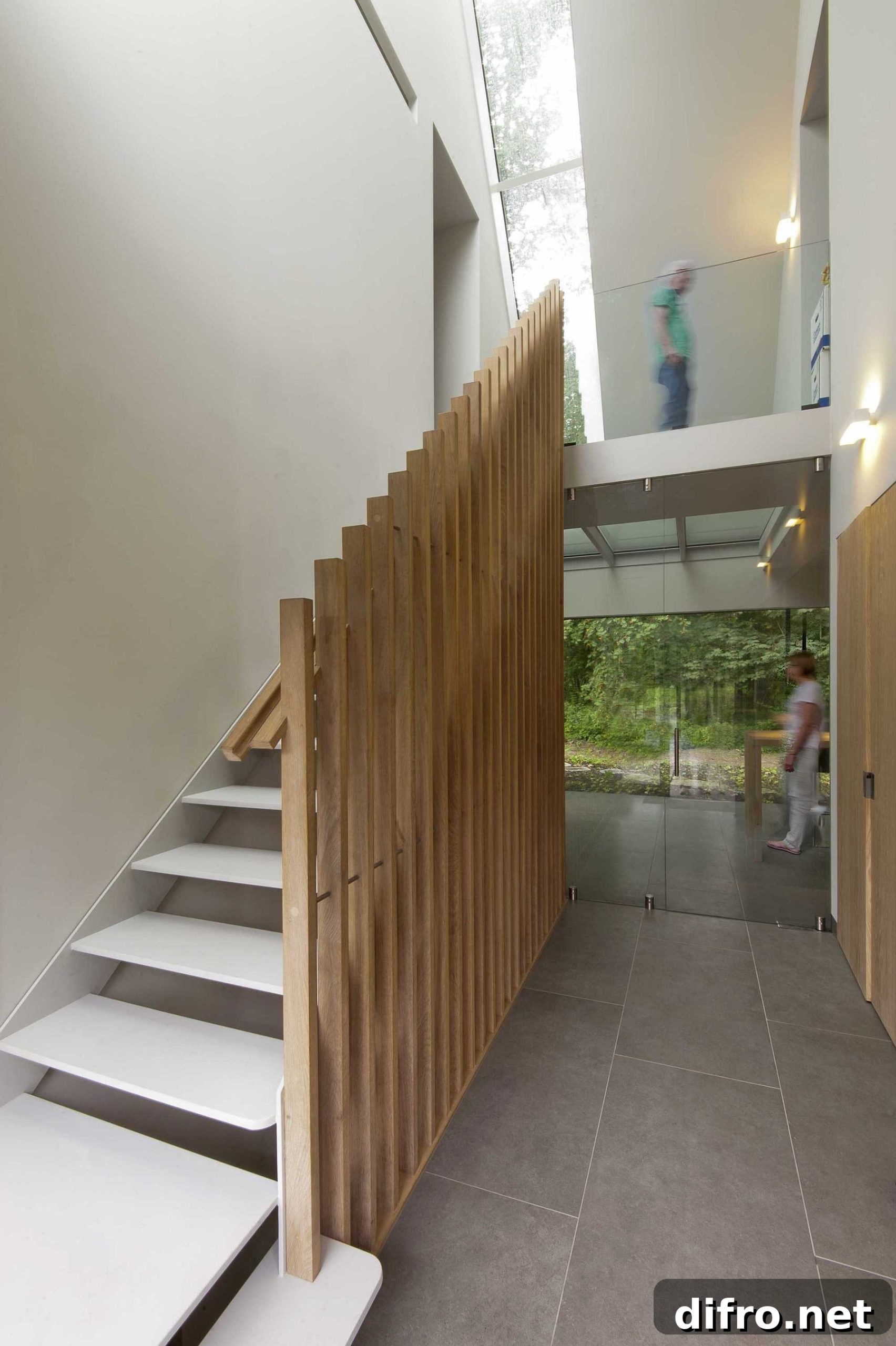 Interior staircase with modified wooden slat railing echoing exterior cladding
