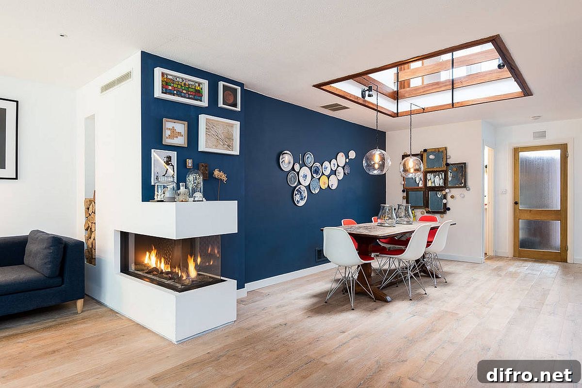 Blue accent wall, skylight and a double-sided fireplace brighten a dining room