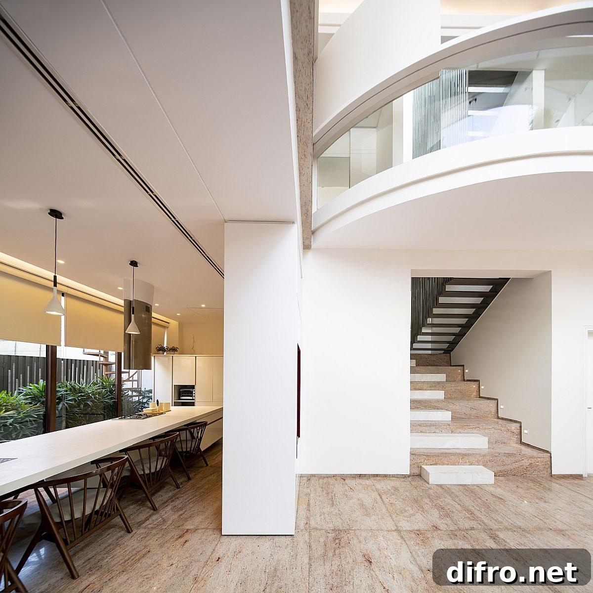 Expansive dining area adjacent to the kitchen with courtyard greenery outside