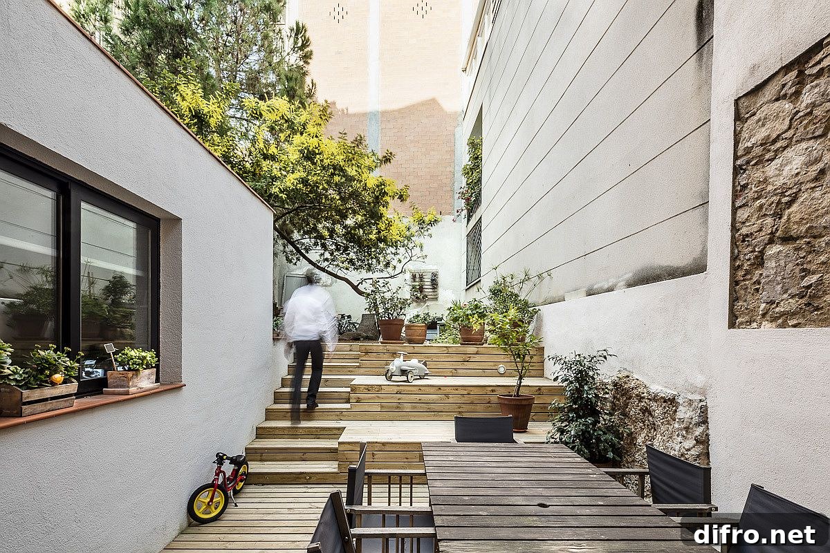 Wooden steps and courtyard leading to private yard