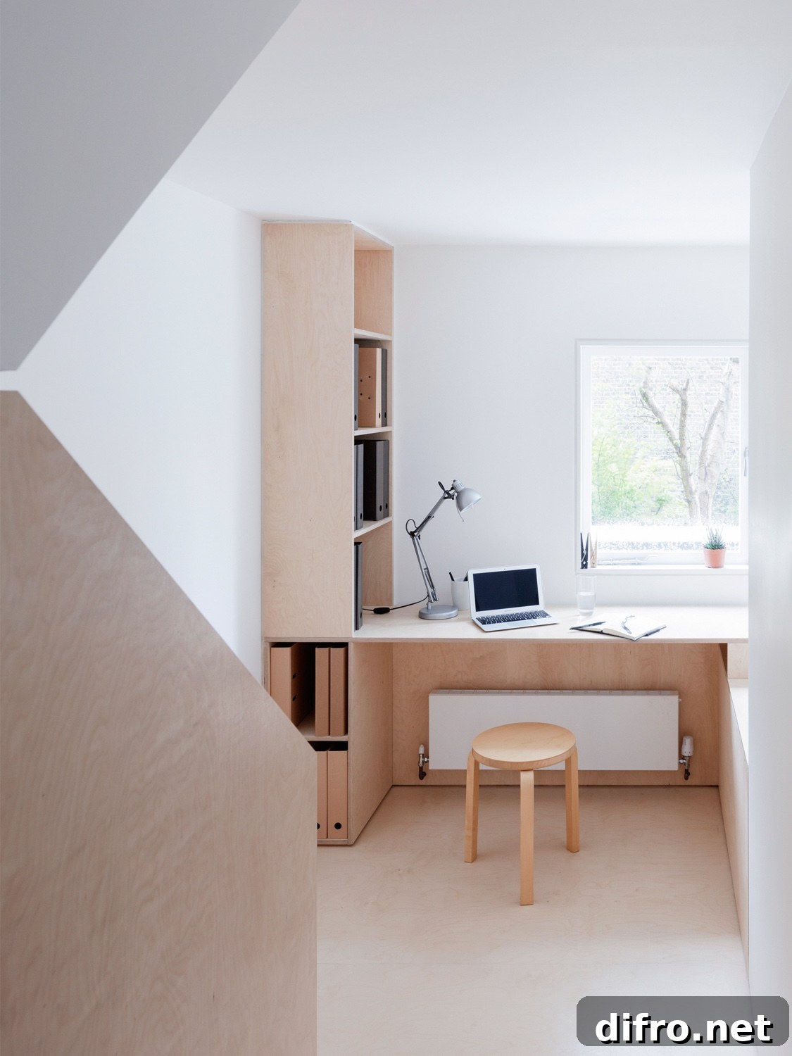 Plywood and white office interior in a London maisonette