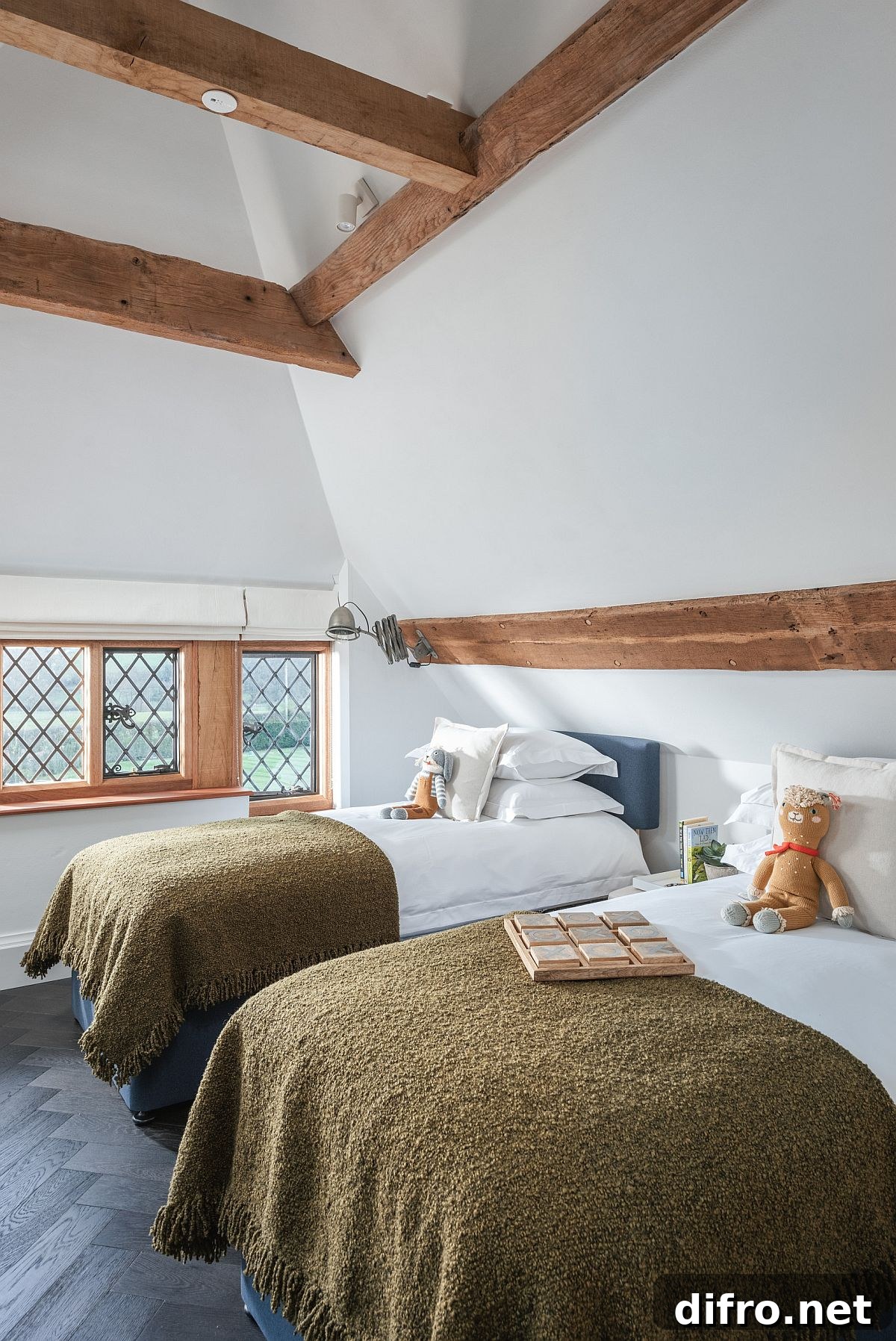 Wooden beams provide warmth to this stylish bedroom in white