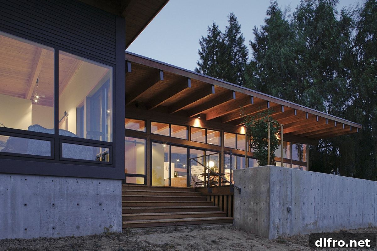 Concrete base with wood and glass walls at the base of the home