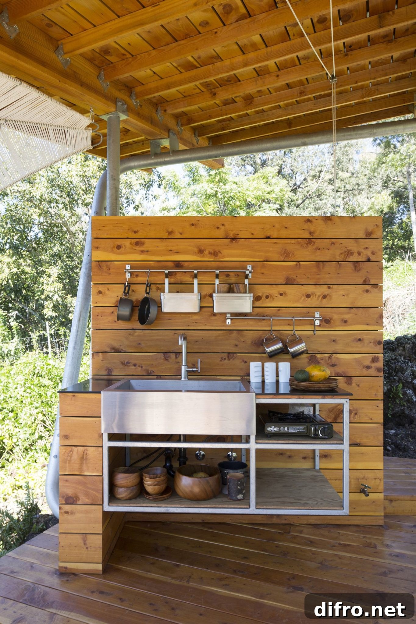 Covered pavilion with outdoor kitchen creates a connection with the landscape
