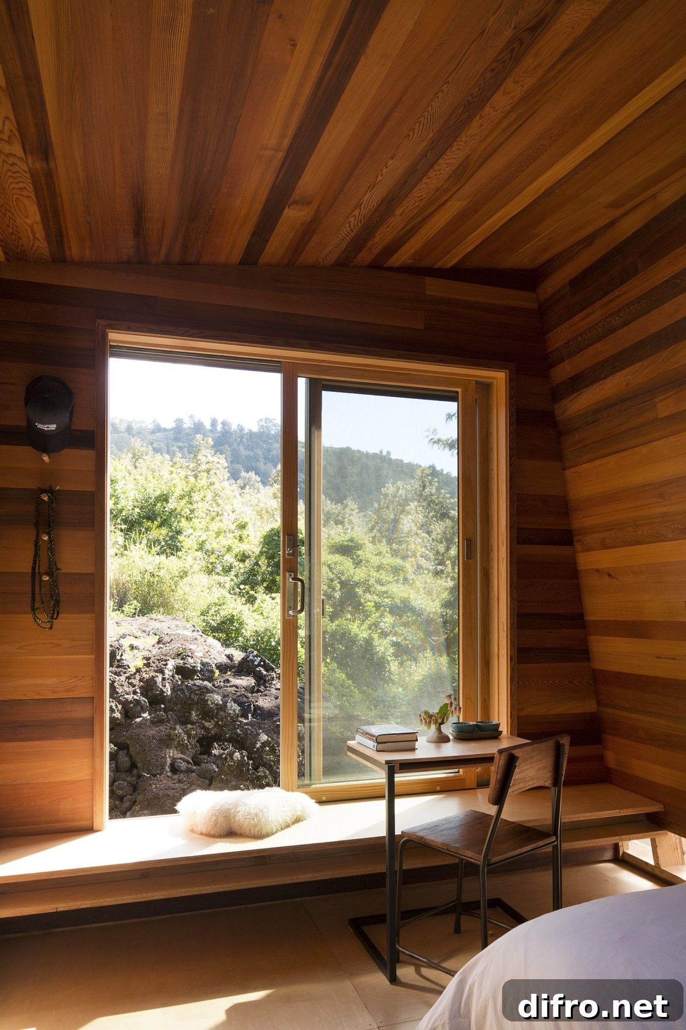 Large bedroom window offers views of the landscape outside