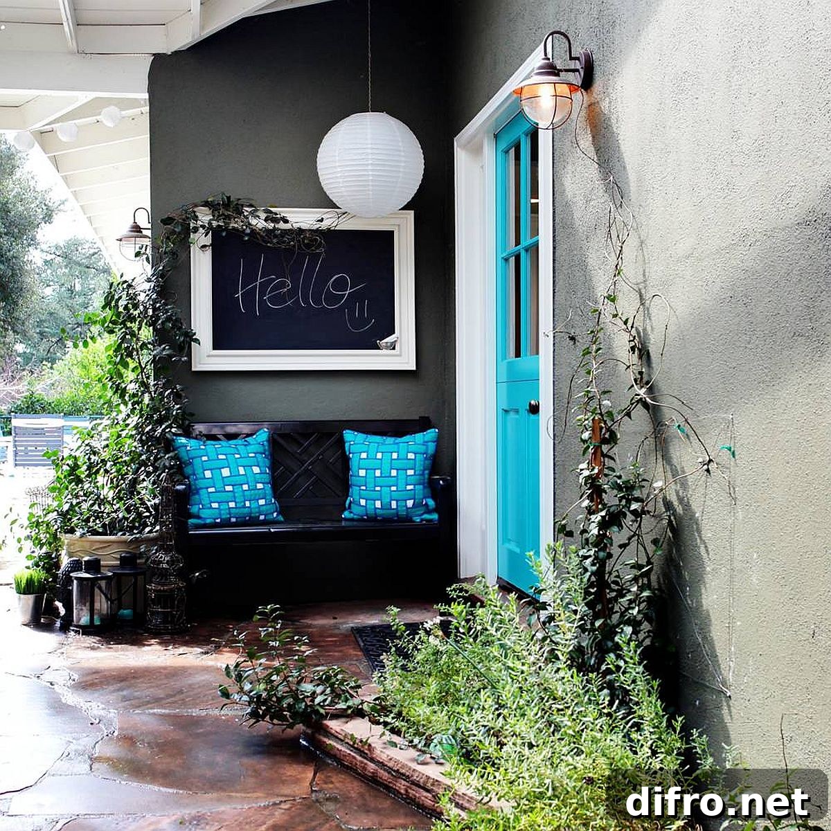 Blue door with matching cushions adding color to a gray and white exterior