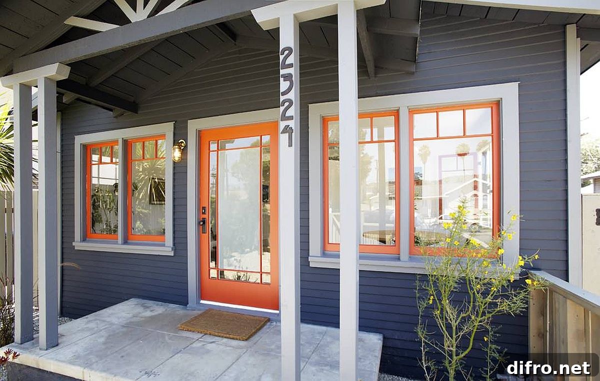 Orange door and window frames brightening a dark gray exterior