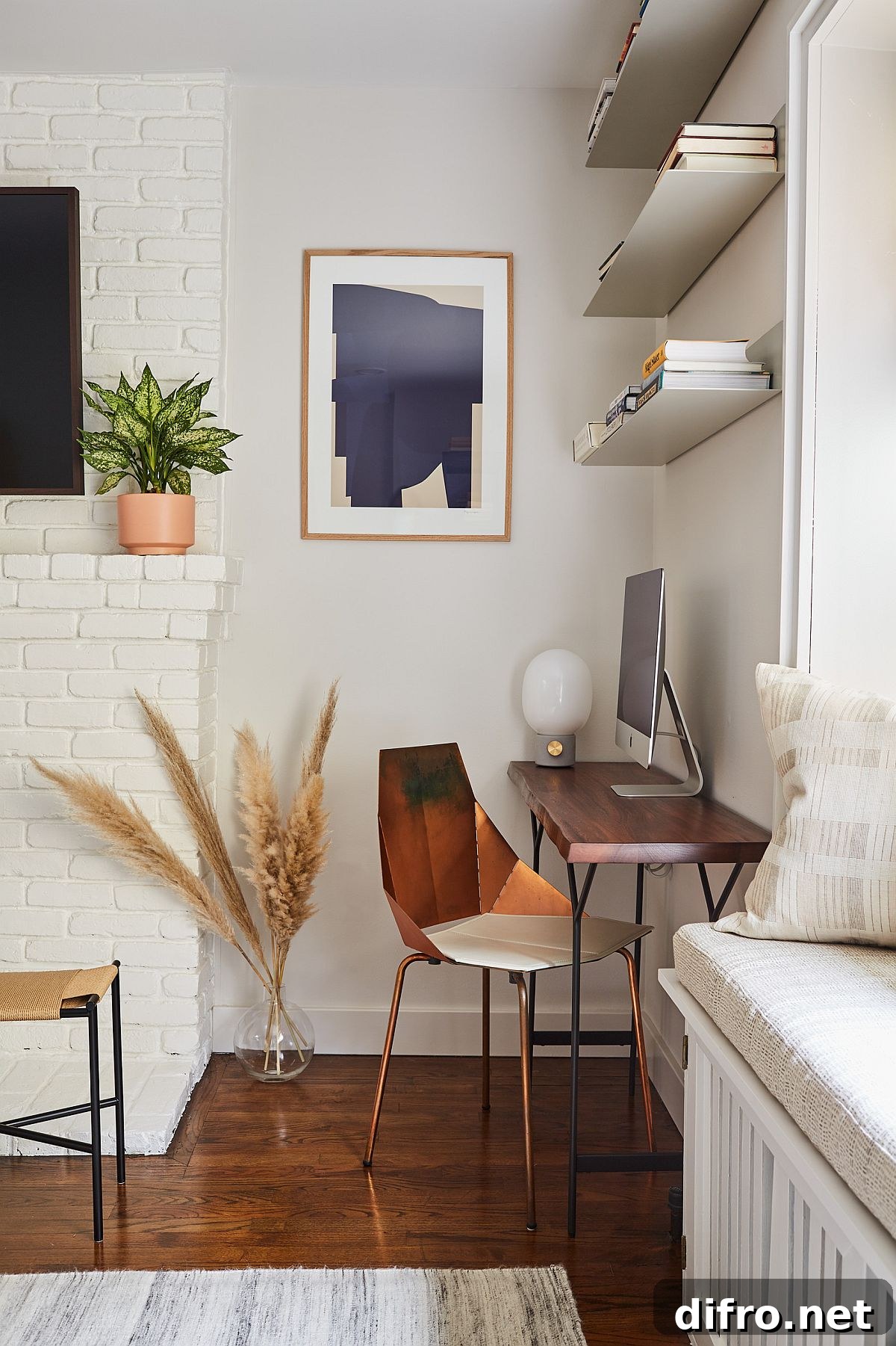 Three floating shelves and desk turn the corner into a cozy workspace