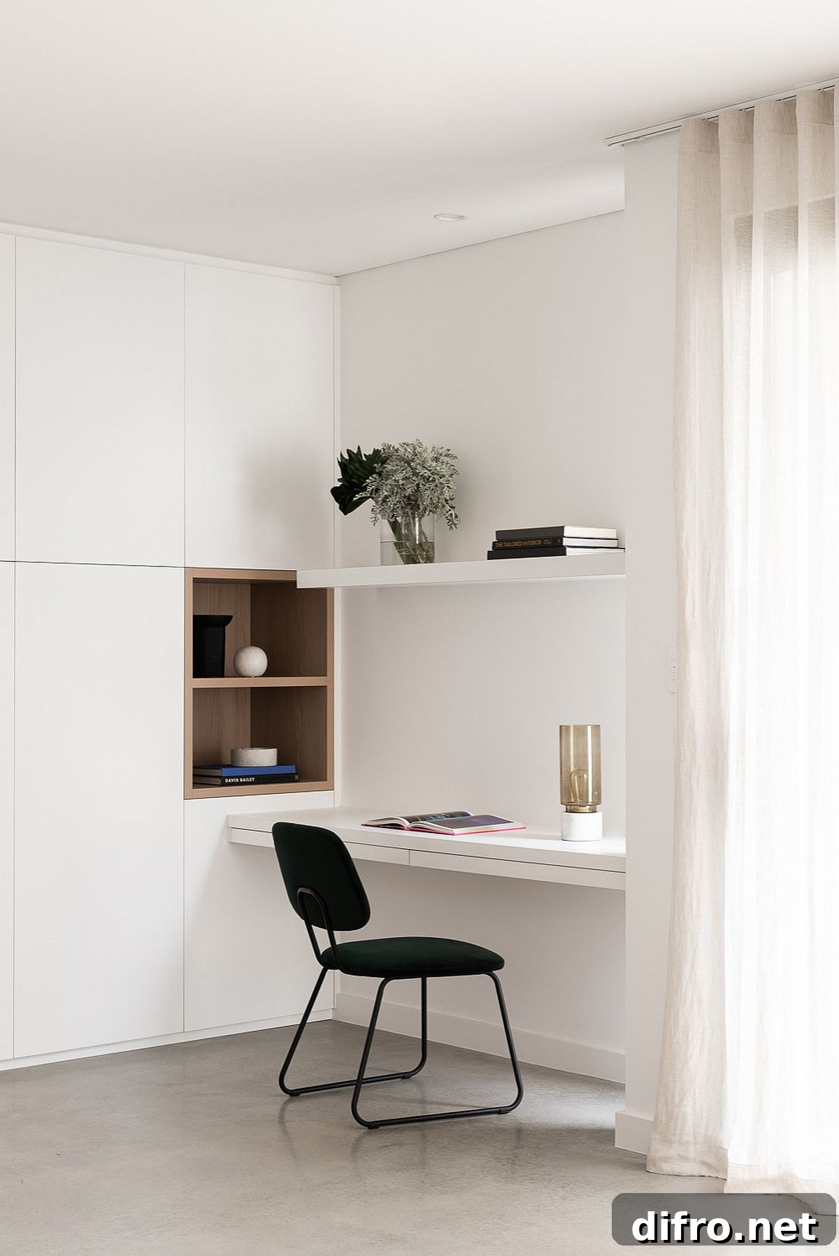 Tiny and minimal workspace in white with a dark chair
