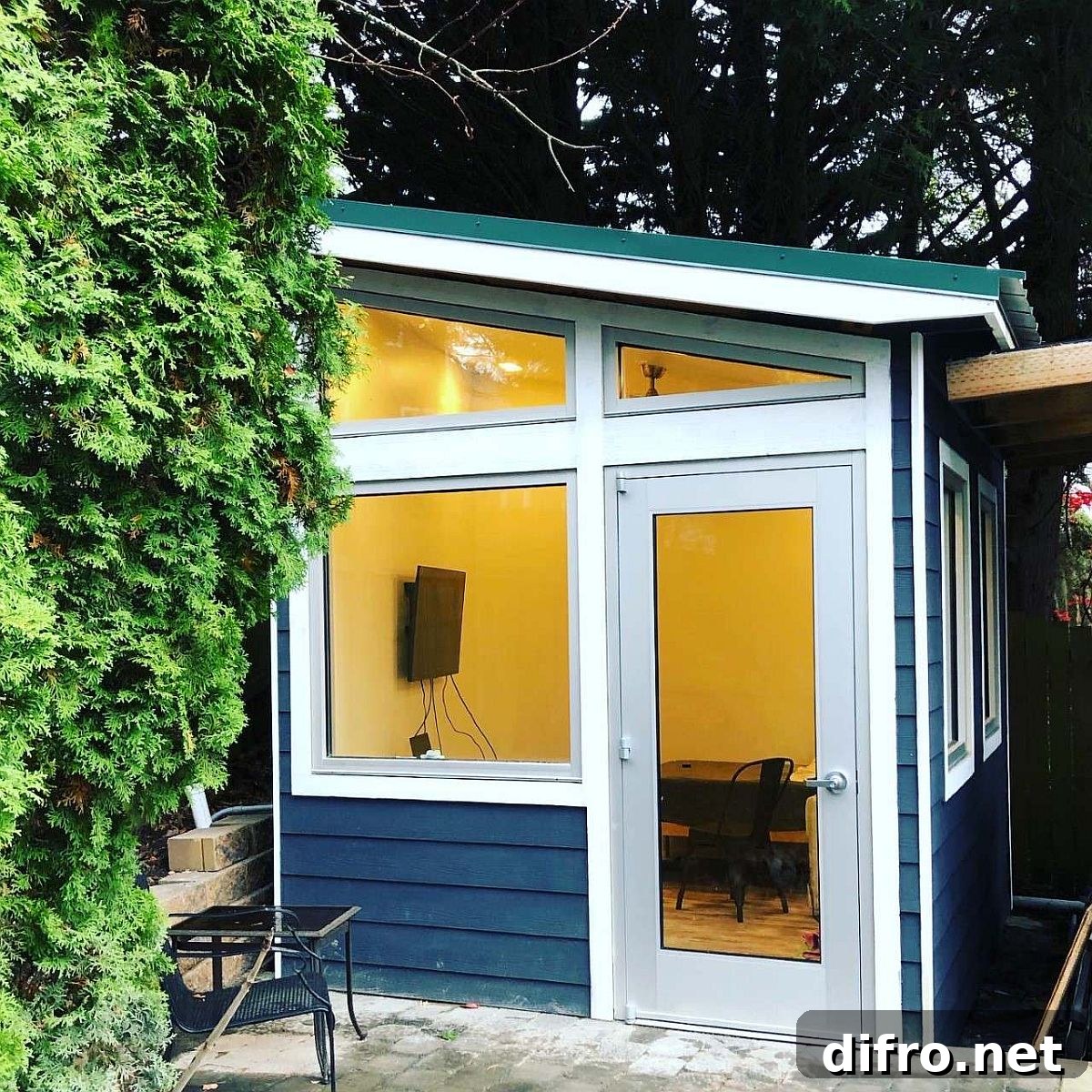 Tiny home office in the backyard with large glass windows