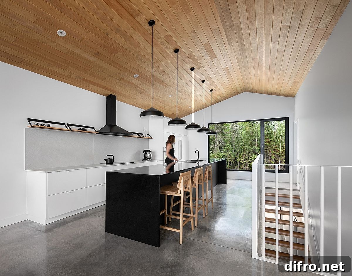 Modern minimal kitchen in wood and white with a dark island
