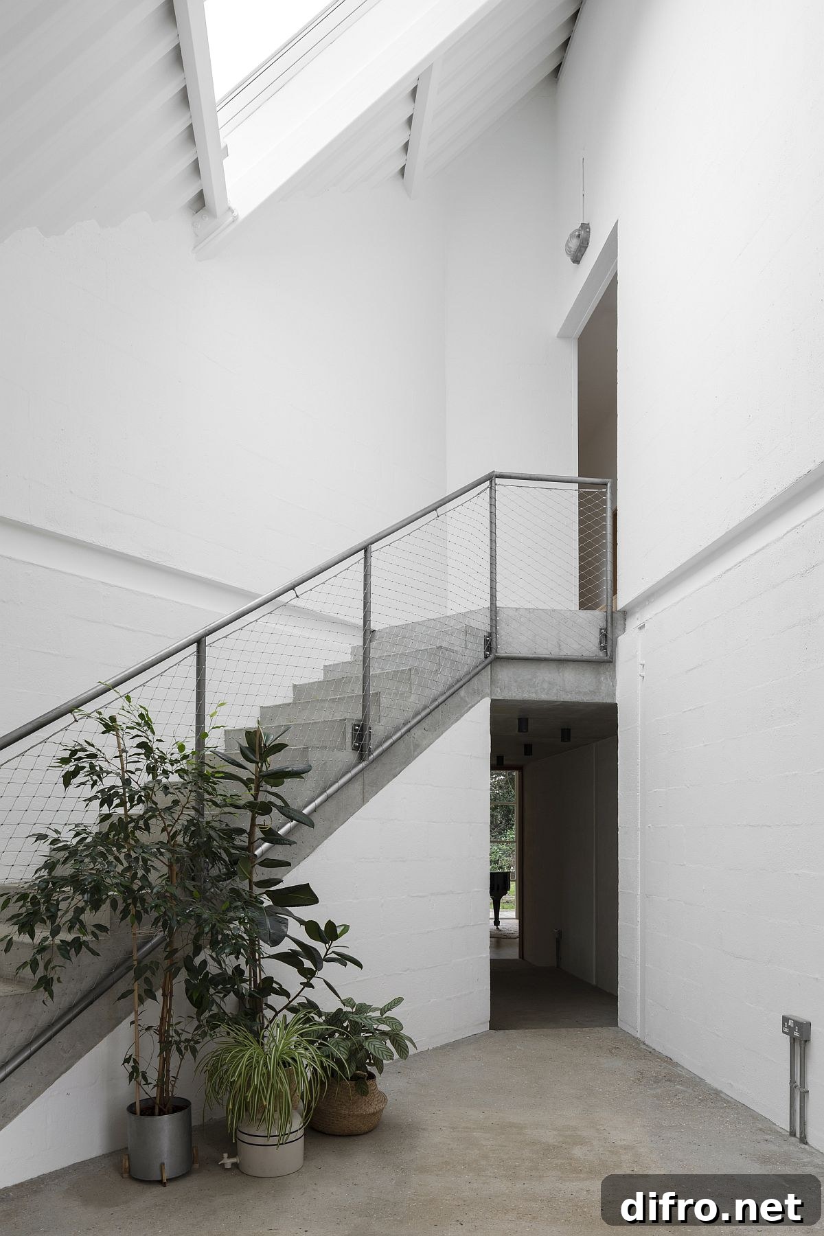 Tall and spacious entrance of the mock tudor home with a white and elegant backdrop