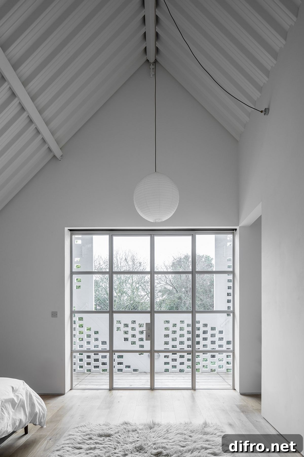 A-frame design of the house adds grandeur to the bedroom as well