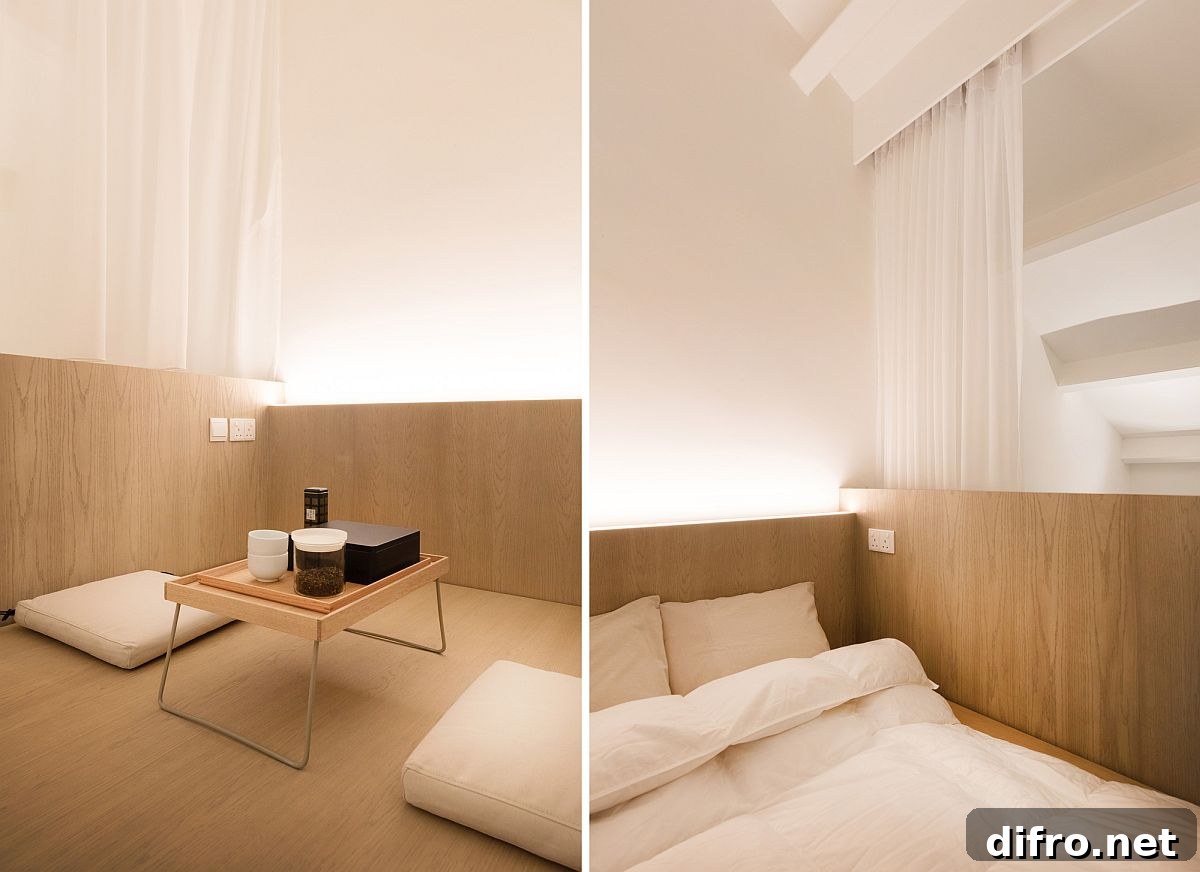 Closer look at the loft level bedroom of the apartment in wood and white