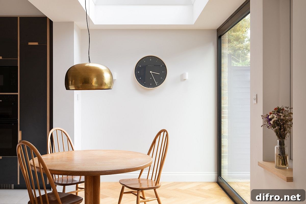 Round dining table with pendant lighting and skylight