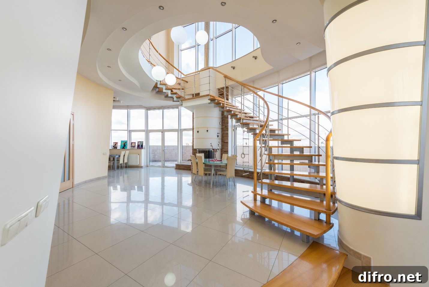 room with high ceiling and winding staircase