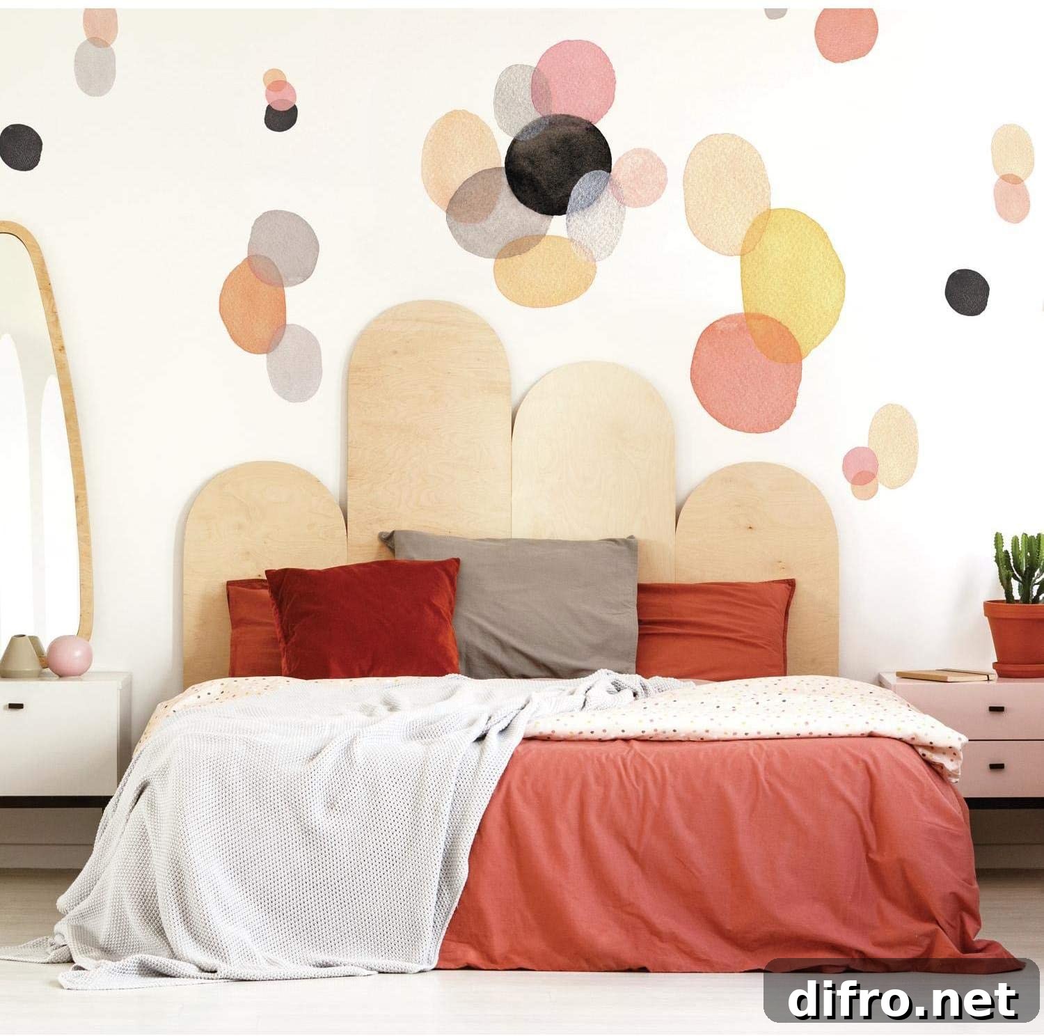 Red bed with pillows and geometric pattern in wall