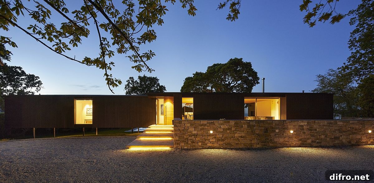 Stone wall border and green pathway leading to the house