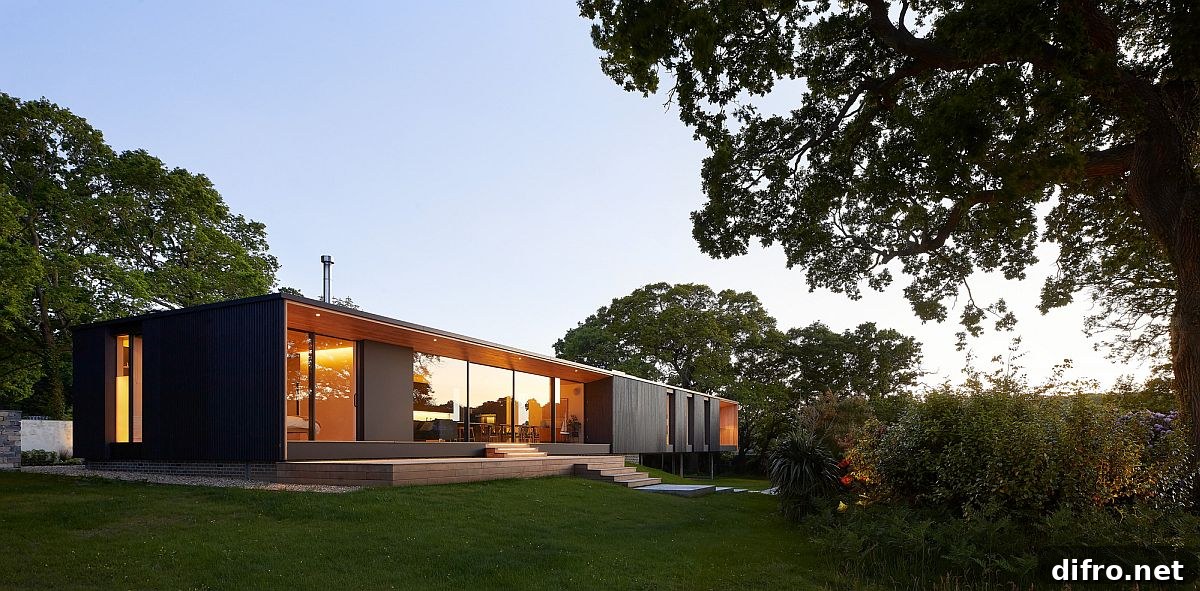 House cantilevered over sloped lot with fixed end below