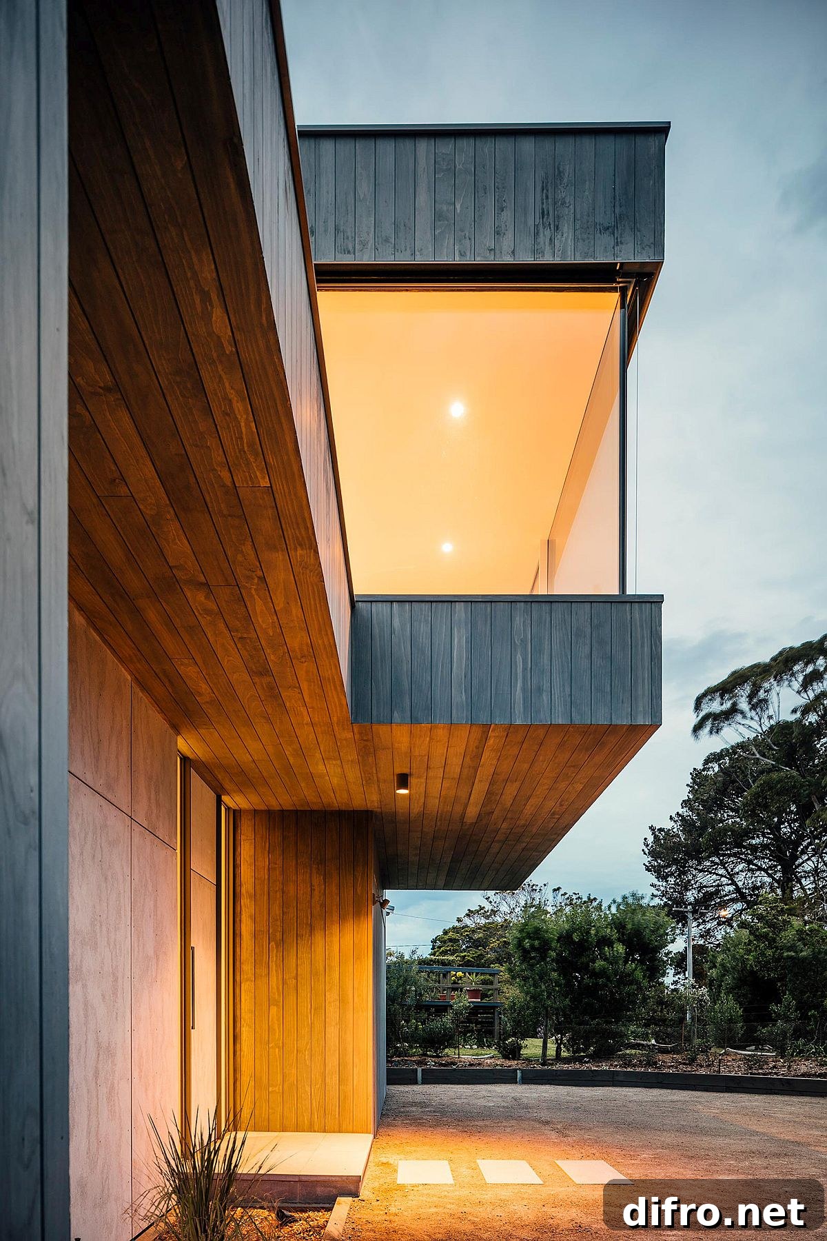 Warm lighting illuminates the fabulous beach house after sunset