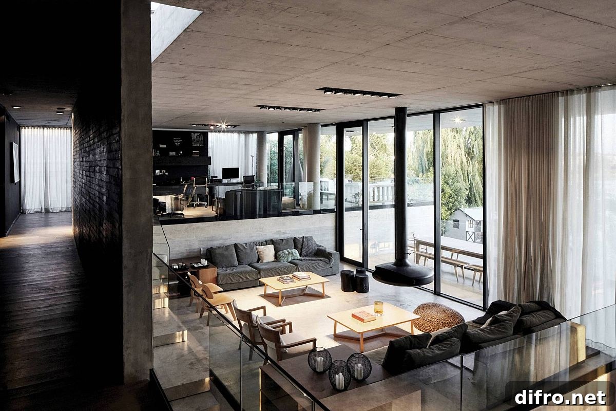 Multi-level interior of the house with study and sitting area above and the living space below