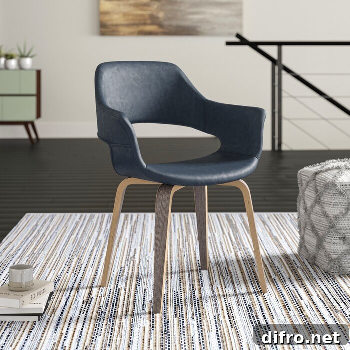 Black leather arm chair with four wooden legs on a grey carpet