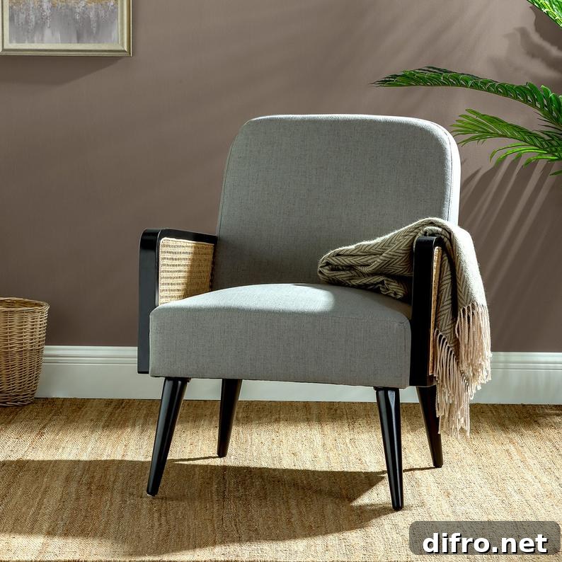 Patterned shawl with fringe on top of a grey armchair